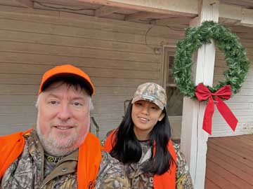 both of us in front of house